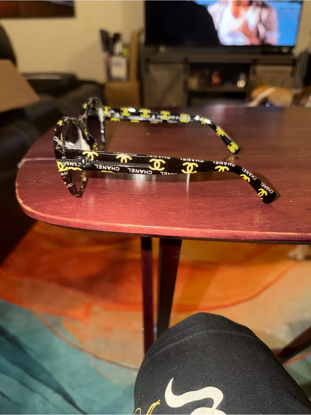 CHANEL Black Frame Sunglasses with Yellow Logo Accents